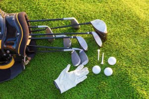 Image of Golf Clubs, Balls and Cloves In Grass.