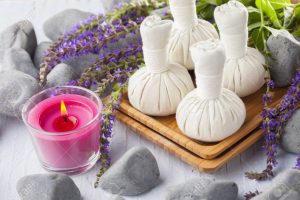 thai herbal compress massage with sage flowers 