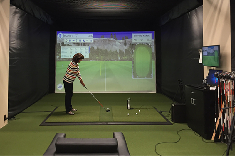 A Female Golf Player practise golf in a visual platform.