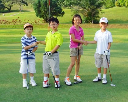 Kids enjoying golf in a playground.