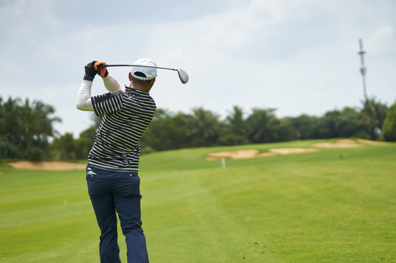 Image showing a super- hit shot of a golfer from golf ground.